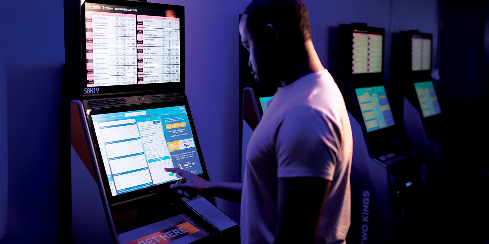 Person placing a bet into the gaming machine.