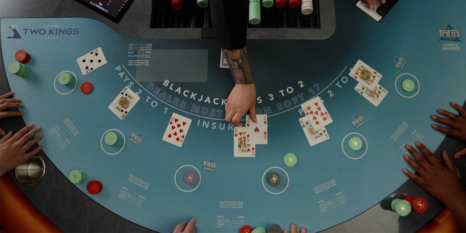 Dealer putting cards on the playing card table